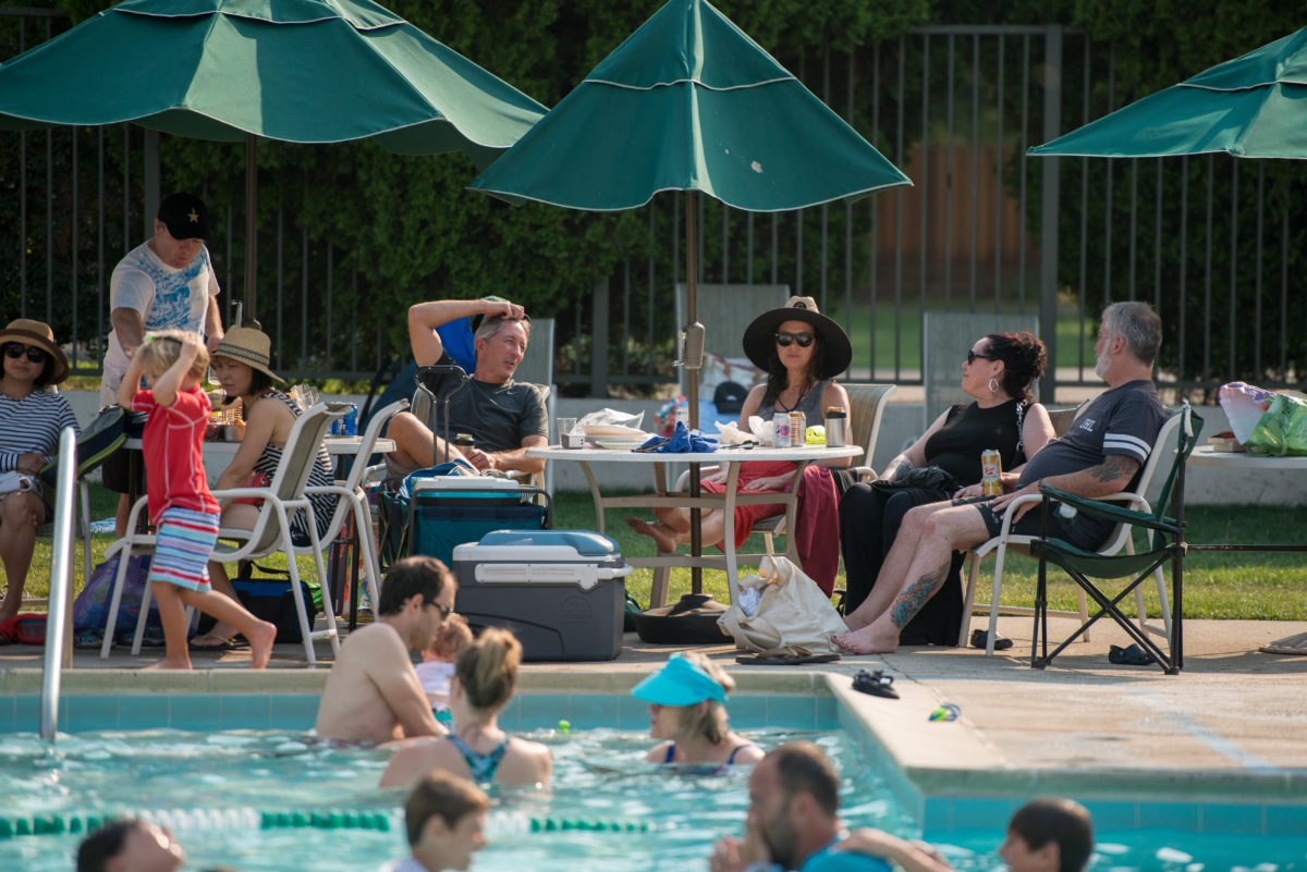 Families relaxing at Greenmeadow Pool